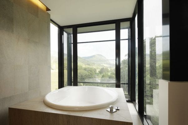 A large bathroom with a tub and a window