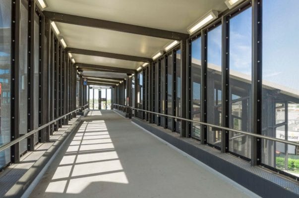 A long walkway with many windows and lights