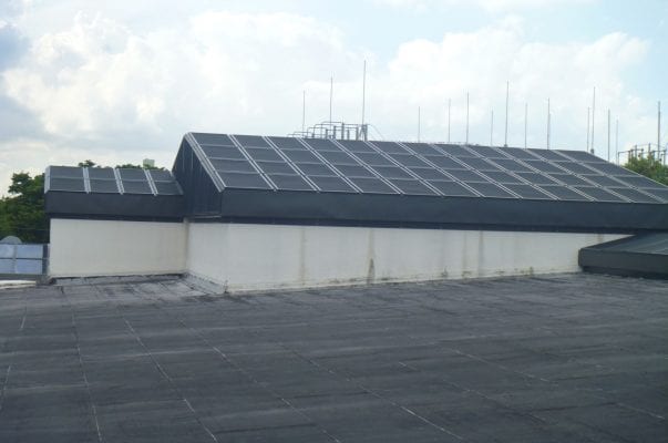 A large building with solar panels on the roof.