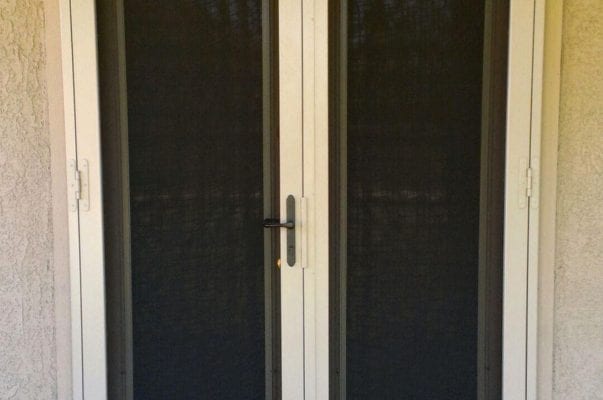 A double door with two black screens on it.