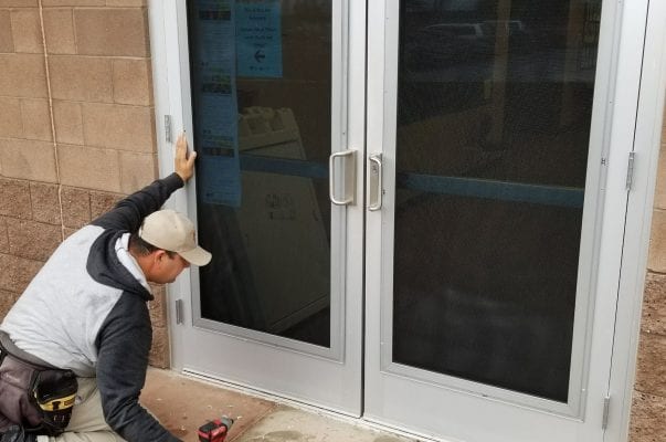 A man is working on the outside of a building.